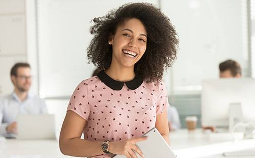 Business woman employee holding digital tablet and smiling